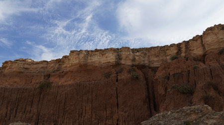 Rocky sea shore and blue sky on sunny  day. Seascape, Mediterranean coastline, layers of rock and stonesの写真素材