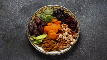 Assorted dry fruits: Dry plum, kiwi, raisins, nuts, pistachios. Tu BiShvat  a Jewish holiday conceptの写真素材