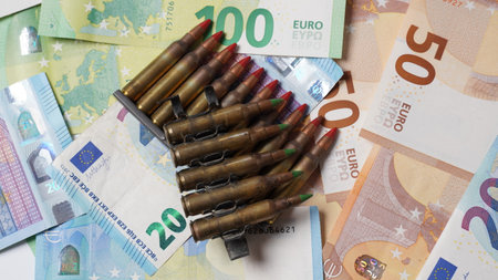 Ammunition from the gun on money bills. Bullets on Euros money, background. Lend-Lease concept. Army concept.の写真素材