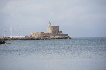 The Fort of St Nicholas and Lighthouse in Mandaki Harbor at Rhodes town, Greece