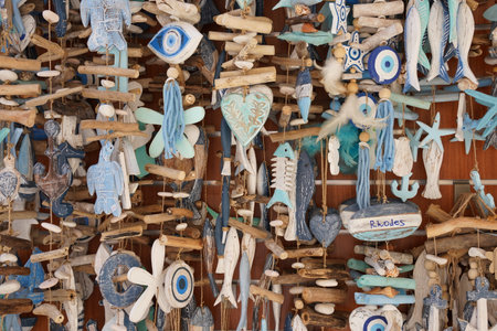 Fish and nautical elements symbol hanging souvenirs off a gift shop boat at Rhodes harborの写真素材