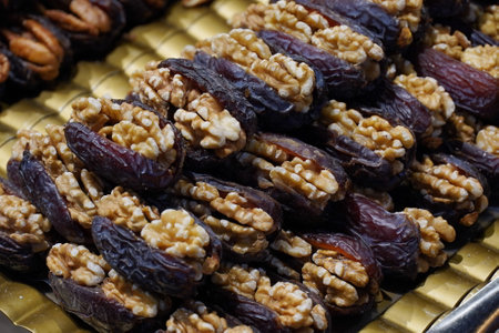 Pile of Walnuts wrapped in date fruit at a local marketの写真素材