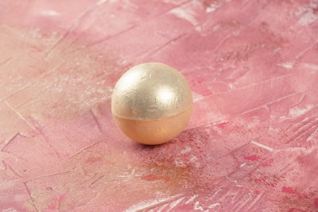 Single bath bomb. Gold aromatic bomb for bathの写真素材