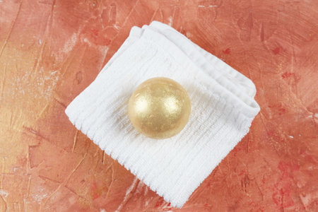 Single bath bomb. Gold aromatic bomb for bathの写真素材