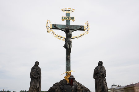 A statue of the holy crucifix  on the historic Charles Bridge in Prague, Czech Republic.の写真素材
