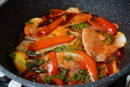 Moroccan fish  with chermoula, red peppers and preserved lemon cooking process. Spicy traditional  Moroccan foodの写真素材