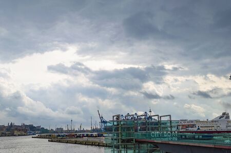 Genoa, Italy - CIRCA 2013: Dramatic clouds above Genoa Harbor.の写真素材