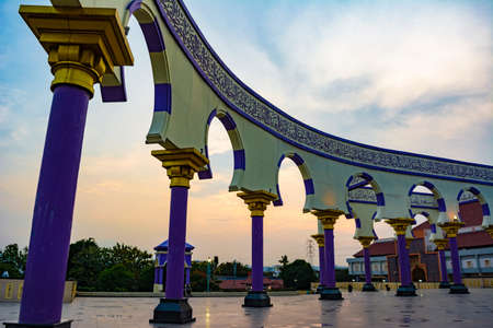 Semarang, Indonesia - CIRCA Nov 2019: The wall with arabic calligraphy and arch decoration in Great Mosque Central Java (Masjid Agung Jawa Tengah) at sunset.のeditorial素材