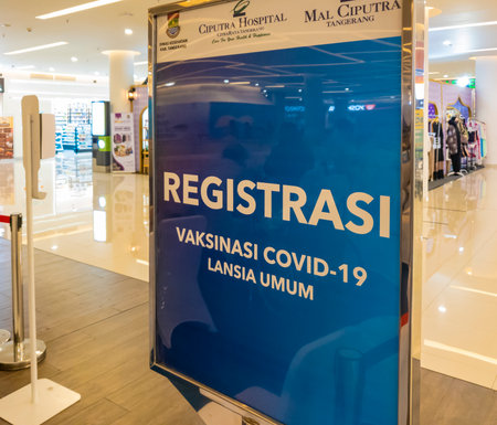 Tangerang, Indonesia - April 2021: Registration board for covid vaccination program for senior citizens (lansia) held inside a mall in Tangerang, Indonesia.のeditorial素材
