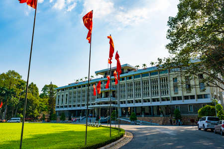 Ho Chi Minh City, Vietnam - CIRCA Jan 2020: The facade of Independence Palace, Ho Chi Minh City, Vietnam; with several Vietnamese national flags around its lawn.のeditorial素材