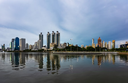 View of Ratchada Lake at cloudy afternoon in Benchakitti Park. Bangkok cityscape at Benjakitti Park.