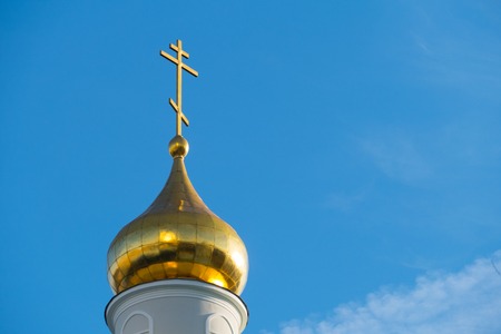 Gilded dome of the church against the blue sky in Moscow on the street Dubininskayaの写真素材