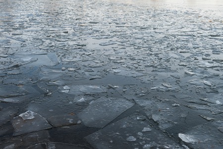 Ice cracked dangerous on the pond in Novemberの写真素材
