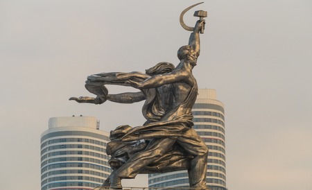 Worker and Collective Farm Girl - symbol on the background of new houses Moscowの写真素材