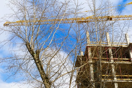 New multi-storey residential building, crane, construction,tree