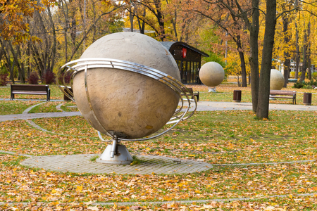 mock globe against the background of autumn yellow foliageの写真素材