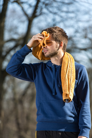 man wipes sweat awayの写真素材
