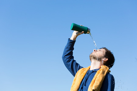 Man pours water in his faceの写真素材