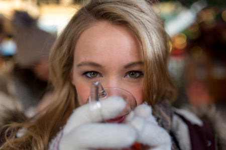 Woman tastes hot Mulled wineの写真素材