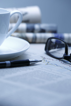 Black pen with financial figures and Glasses,shot with very shallow depth of field.blue tone,の写真素材