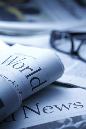 Glasses on newspaperand black pen.shot with very shallow depth of field, blue tone.の写真素材