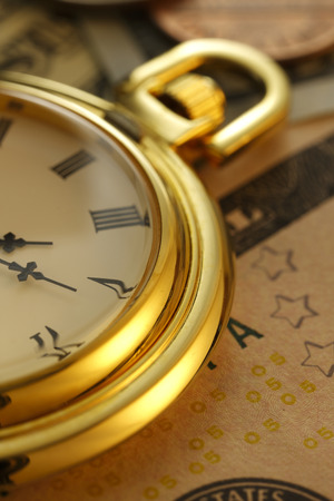 Time is money. Gold Tone. Clock in US dollarsの写真素材