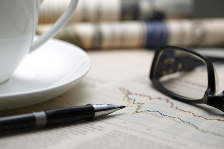Black pen with financial figures and Glasses,shot with very shallow depth of field.の写真素材