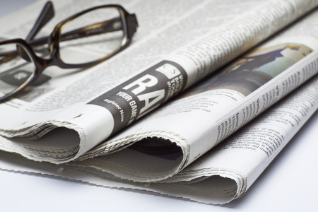 Glasses on newspaper,shot with very shallow depth of field.の写真素材
