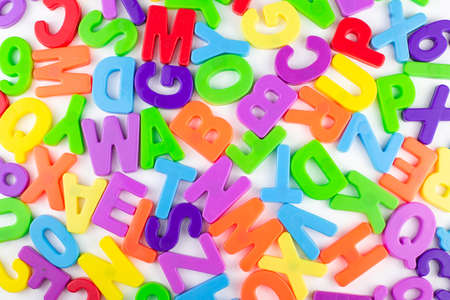 colorful letters are randomly scattered on a white backgroundの写真素材