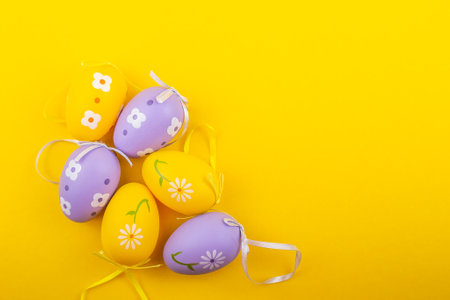 Colored easter eggs with patterns on a yellow background.の写真素材