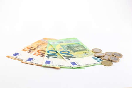 Euro banknotes and coins on a white backgroundの写真素材