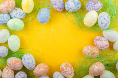 Easter decor in the form of eggs on a yellow background