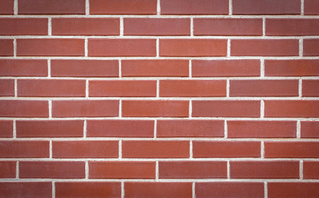 Red brick wall made of smooth brick. Seamless smooth brick wall. Brick wall background, copy space...