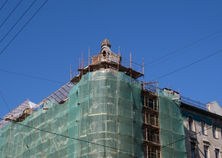 Historic building with a tower in scaffoldingの写真素材