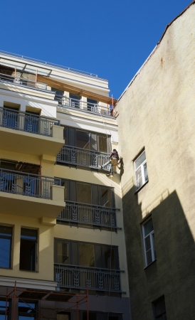 The painter paints a cradle suspended in a historic buildingの写真素材