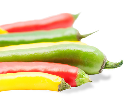 Colorful chili peppers isolated on whiteの写真素材