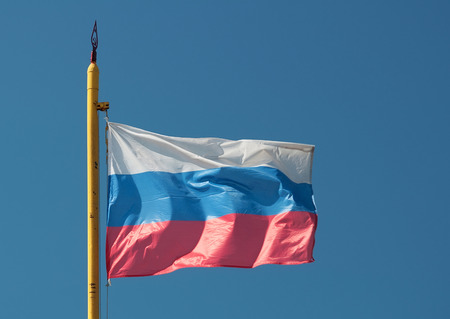 Russian flag on rusty Soviet flagpoleの写真素材