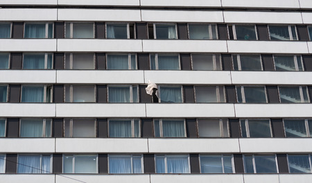 Wall multistory building with billowing white curtainの写真素材