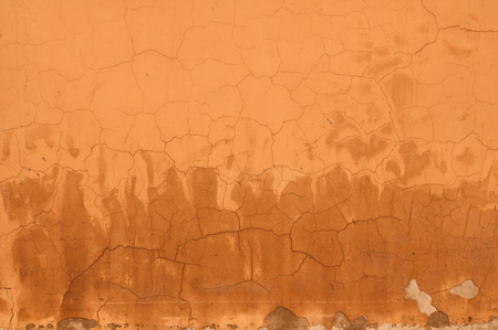 Texture of old cracked wall with yellow stuccoの写真素材