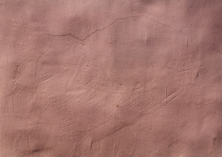 Texture of old wall covered with pink stuccoの写真素材