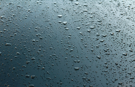 Texture black car hood with many rain dropsの写真素材