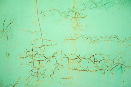 Texture of old iron covered with cracked walls, painted with green paintの写真素材