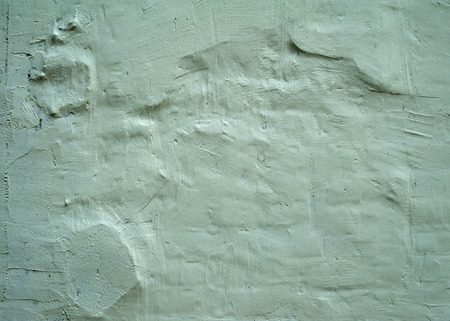 Texture of old rustic wall covered with green stucco