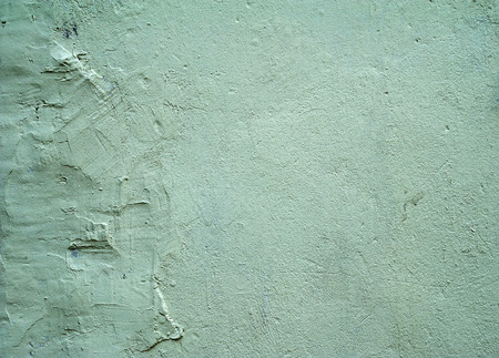 Texture of old rustic wall covered with green stuccoの写真素材