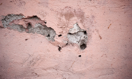 Texture of old rustic wall covered with pink stuccoの写真素材