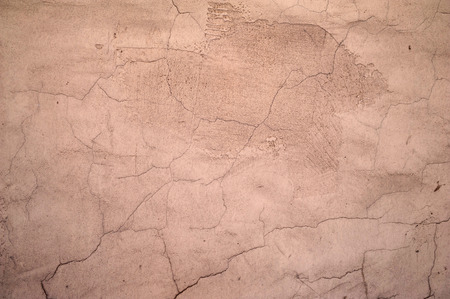 Texture of old rustic wall covered with pink stucco