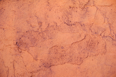 Texture of old rustic wall covered with pink stuccoの写真素材