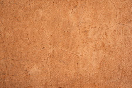 Texture of old rustic wall covered with brown stuccoの写真素材