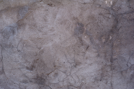 Texture of old rustic wall covered with gray stuccoの写真素材
