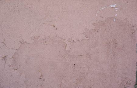 Texture of old rustic wall covered with pink stuccoの写真素材